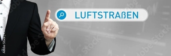 Fototapeta Luftstraßen. Mann zeigt mit Finger auf Suchfeld im Internet-Browser. Wort/Text (blau) in der Suche.