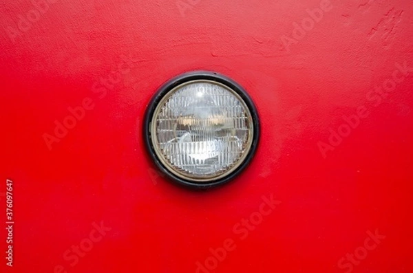 Fototapeta Retro round headlight on red background.