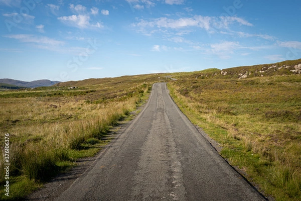 Fototapeta Straight single track road with turns at the end in Scottish Highlands, UK. Beautiful summer sunny day