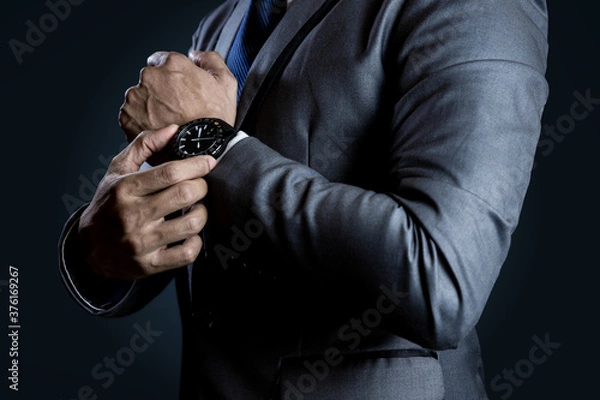 Fototapeta Businessman checking time on watch