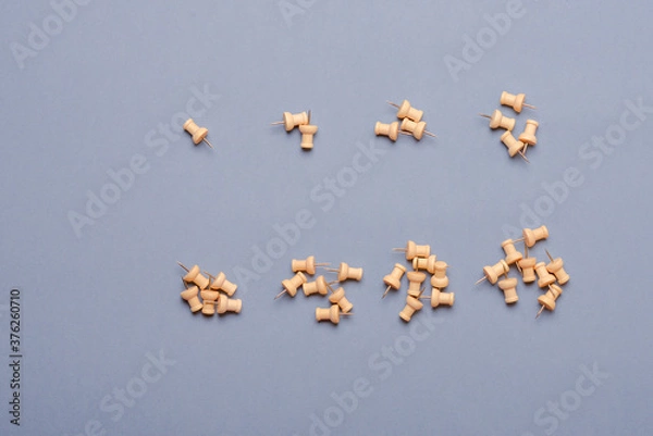 Obraz Push pins on background in 8 groups