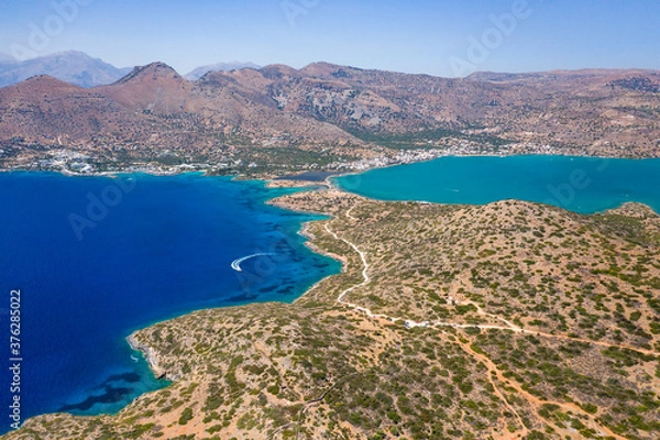 Fototapeta Aerial view of the rugged coastline of Crete and the clear waters of the Aegean Sea (Elounda, Greece)