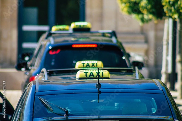 Obraz View of a traditional taxi for passengers parked in the historical streets of Reims, a city in the Grand Est region of France and one of the oldest in Europe
