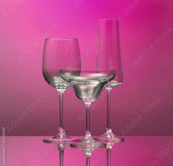 Fototapeta Empty glasses on color background