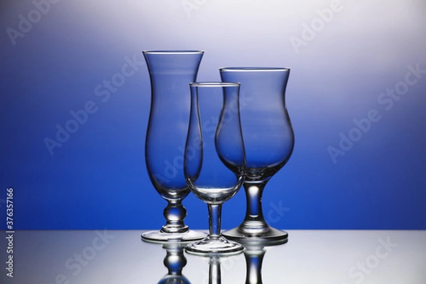 Fototapeta Empty glasses on color background