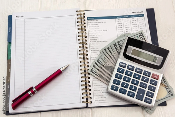 Fototapeta calculator and pen with empty sticker on dollar bills