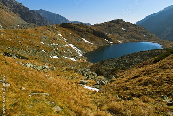 Fototapeta Mountain lake in autumn with first snow and clear sky