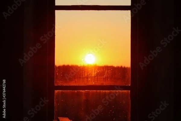 Fototapeta sunset though a window 