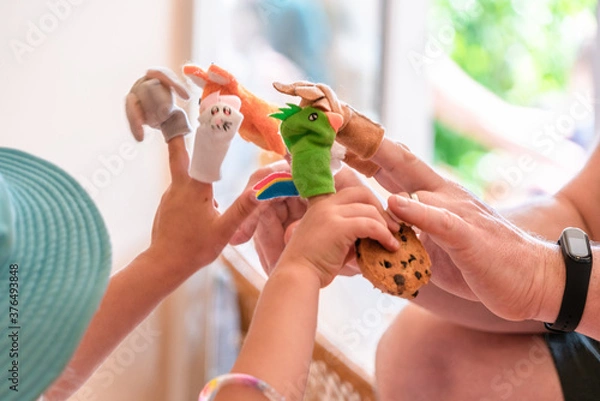 Fototapeta Child with finger puppets with a parent