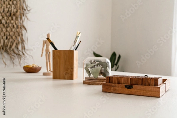 Fototapeta Modern wooden objects in a white workspace on a table