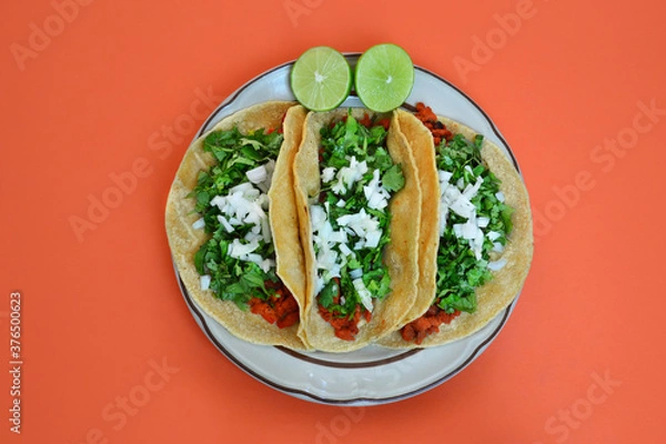 Fototapeta Three delicious mexican tacos with onion and coriander.