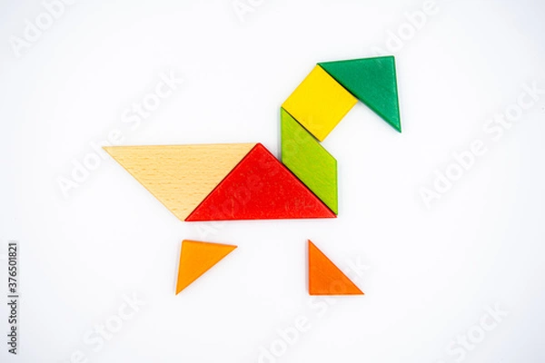 Fototapeta Color wood tangram puzzle in Duck shape on white background