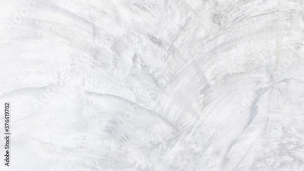 Fototapeta White cement wall background in vintage style for graphic design or wallpaper. Pattern of soft concrete floor in retro concept.