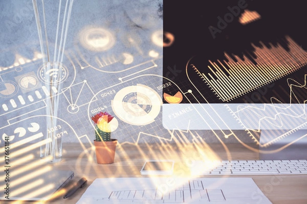 Fototapeta Computer on desktop in office with technology theme hologram. Double exposure. Tech concept.