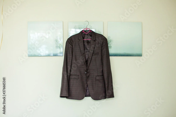 Obraz a man's jacket hangs on a white wall