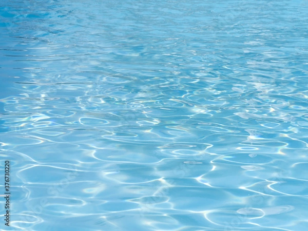Fototapeta Reflections on a surface of a water in a pool.