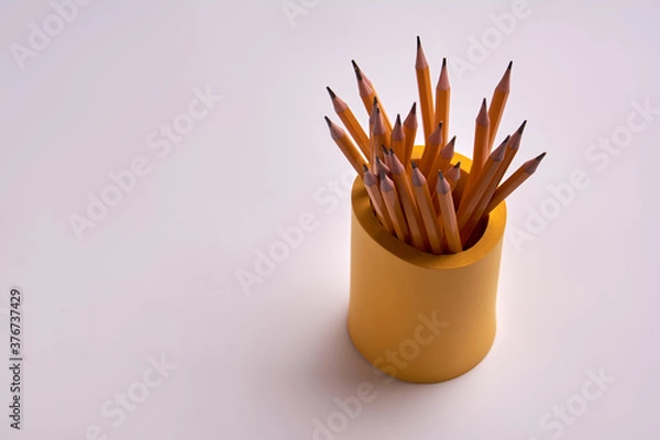 Obraz pencils in a yellow glass on a white background