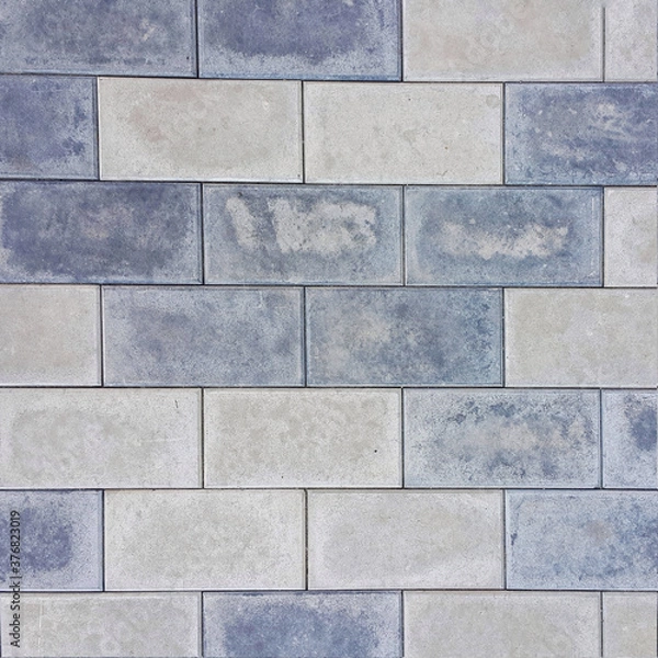 Fototapeta Background of the brickwork. Structural material. For designers. Interior of the building facade. Masonry. Construction industry. The color is gray. Square photo.