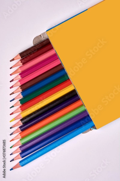 Obraz colored pencils packaged on a white background