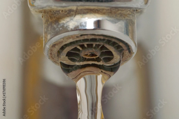Fototapeta Water dripping from a faucet in the bathroom