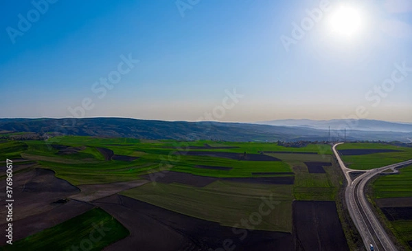 Fototapeta Aerial view to the fertile and arable fields in the spring season ready for sowing