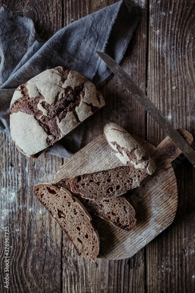 Obraz homemade bread on a cutting Board on a wooden table