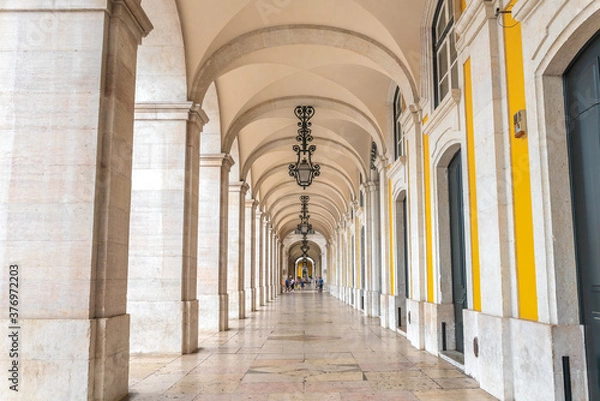 Fototapeta Arcade with beautiful lamps and architectural details in Praca do Comercio, Lisbon - Portugal