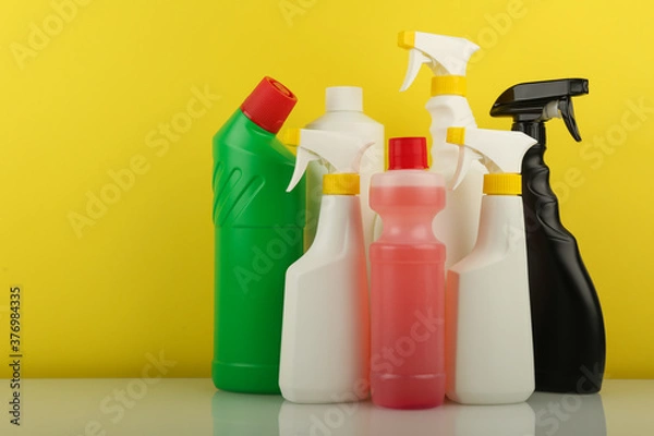 Fototapeta group of cleaning and detergent products on yellow background