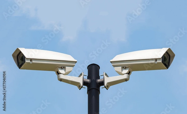 Obraz Two CCTV Security camera on clear sky background