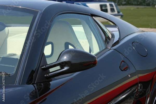 Obraz Sports car with helicopter in background