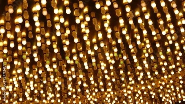 Fototapeta Old fasioned electric lamps blinking and glowing at night. Abstract close up of retro casino decoration shimmering in Las Vegas, USA. Illuminated vintage style bulbs glittering on Freemont street