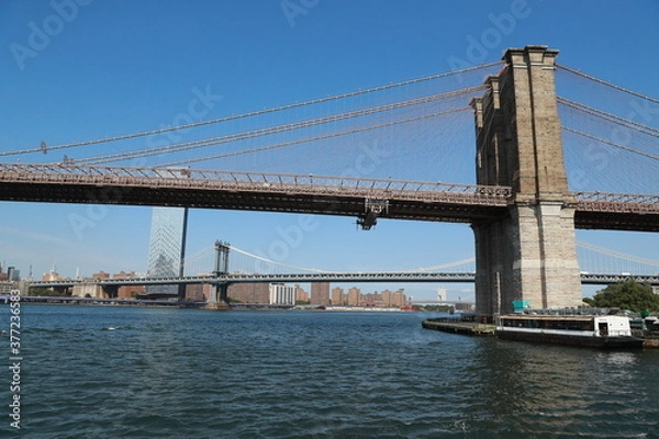 Fototapeta A view of the Brooklyn Bridge from the East River in New York City.