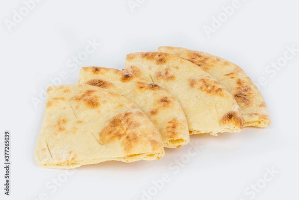 Obraz Triangular slices of pita bread shot on a white background