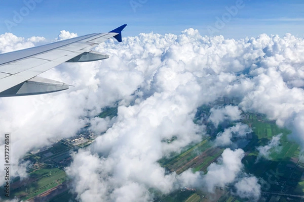 Obraz view from airplane window with puffy clouds 