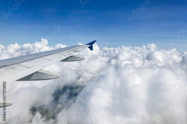 Obraz view from airplane window with puffy clouds 