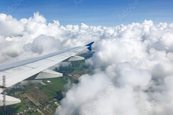 Obraz view from airplane window with puffy clouds 