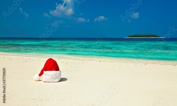 Obraz Santa hat is on a beach