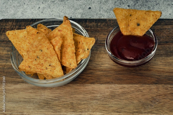 Fototapeta Corn cheese, snacks with sauce on a wooden stand. Beer snack, dish on the menu. Close up.
