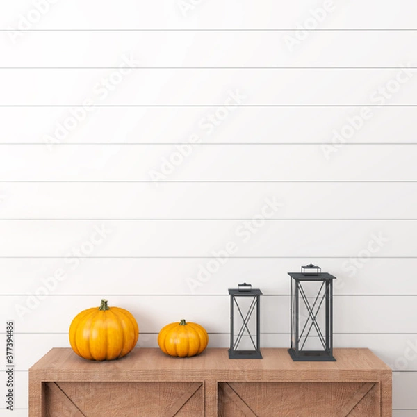 Fototapeta halloween pumpkin on a wooden table in front of a white wall with two black lanterns 