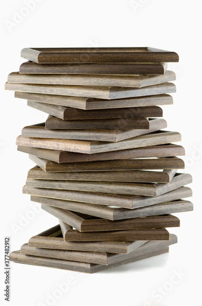 Fototapeta Rectangular wooden frame for pictures and many lay stacked vertically on a white background.