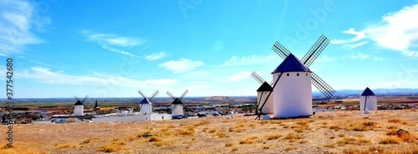 Fototapeta Artistic photo of windmills with Campo de Criptana town in the background.