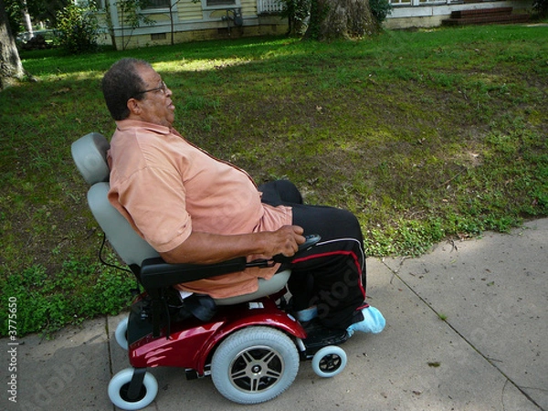 Fototapeta Man Riding Power Chair