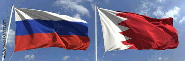 Fototapeta Waving flags of Russia and Bahrain on flagpoles, 3d rendering