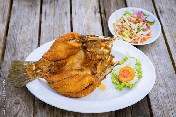 Fototapeta Deep Fried Snapper topped with sweet fish sauce and mango salsa.
