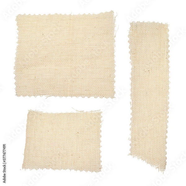 Obraz Square, rectangular long pieces of canvas, cut burlap fabric, patch for clothes, dry garbage, scraps of fabric, background for text from fabric isolated on a white background.