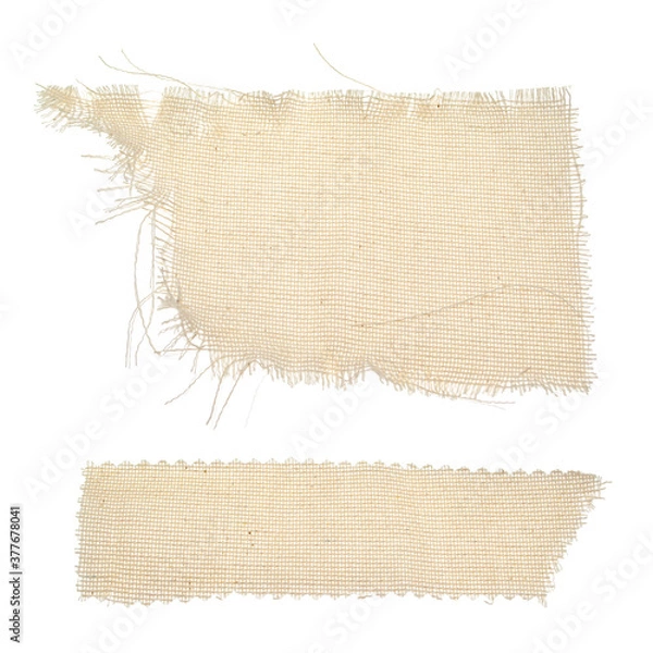 Obraz Pieces of ragged burlap shreds. Rectangular canvas patches. Texture background fabric in beige color isolated on a white background. The patch, cloth, garbage, dry waste, scraps of clothing.