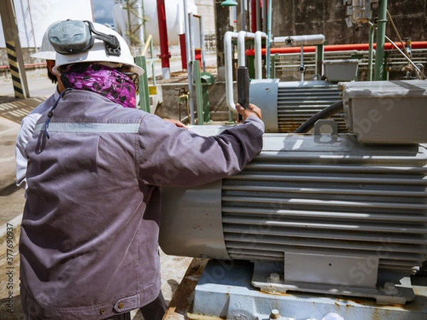 Fototapeta Technician checking and reading data vibration measurement of motor in power plant.
