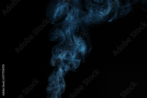 Fototapeta blue smoke from incense on a black background