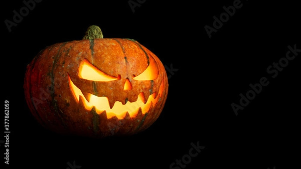 Obraz halloween pumpkin with glowing eyes and mouth isolated on black background closeup with copy space