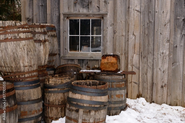 Fototapeta Old barrels outside the cooperage in winter at Pioneer Village